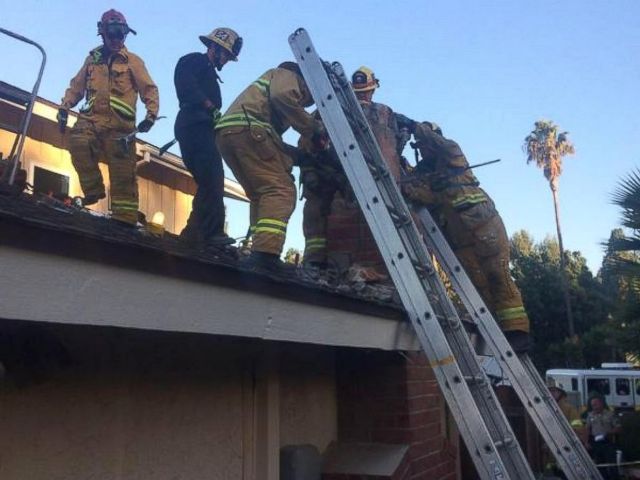 firefighters rescuing genoveva nunez-figueroa from the chimney in which she was stuck