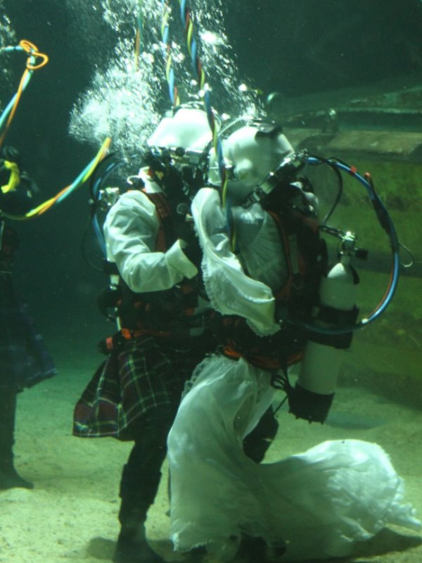 james kissing his bride, dorota during the underwater wedding ceremony