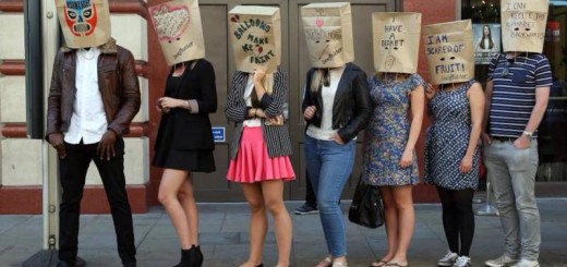 participants wearing paper bags, ready for the speed dating event