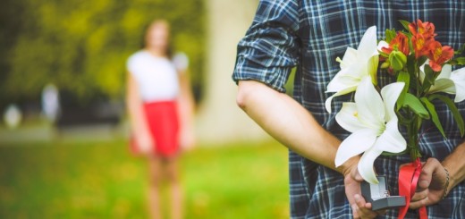 man holding flowers behind his back_New_Love_Times