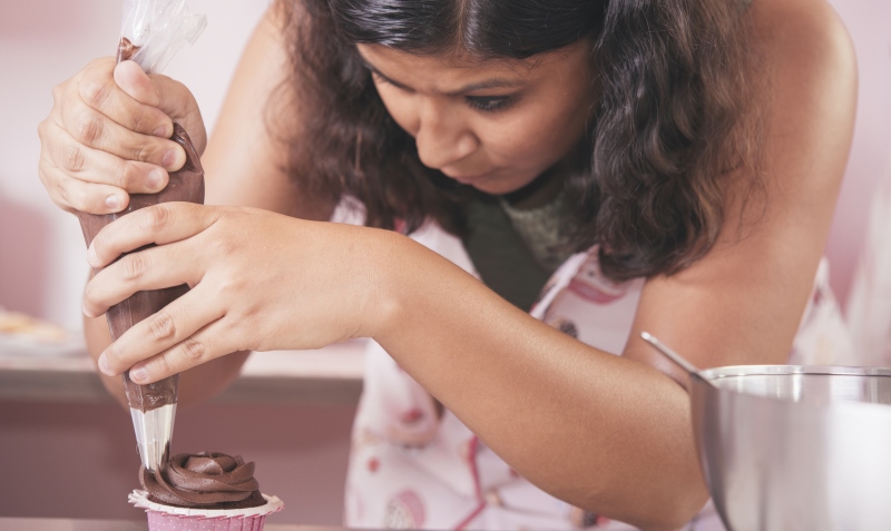 woman icing a cupcake_New_Love_Times