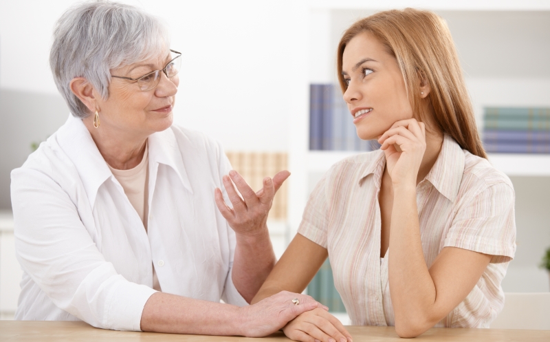 younger woman talking to an older woman