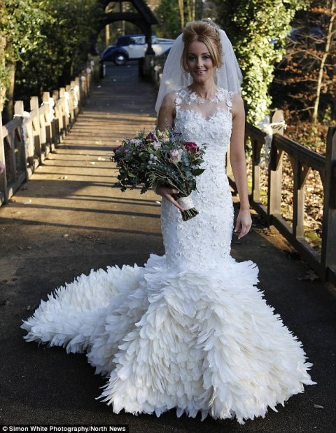 cheryl mcglynn wearing the stunning gown she created by hand-stitching 22,000 goose feathers onto it