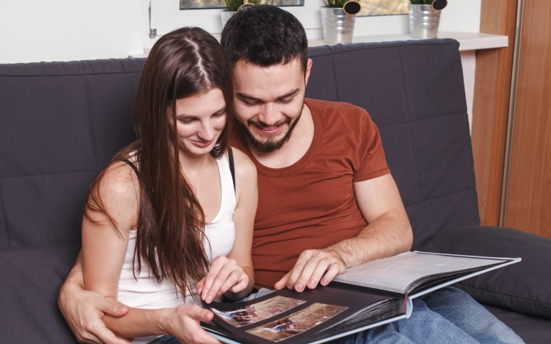 couple looking at an album together_New_Love_Times