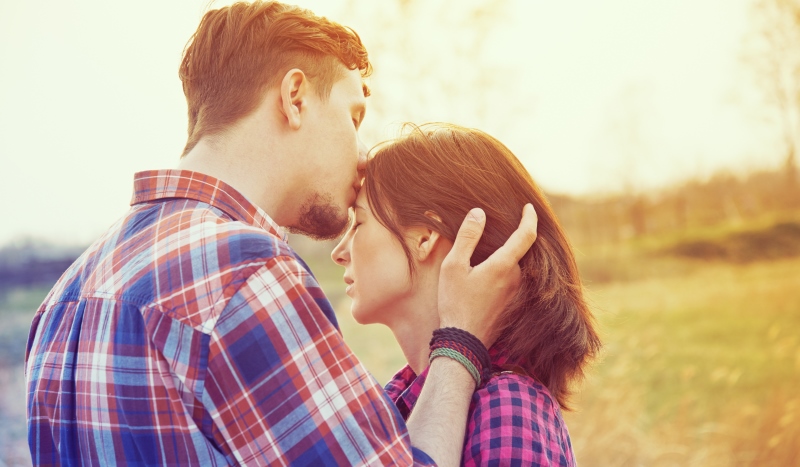 man kissing a woman's forehead_New_Love_Times