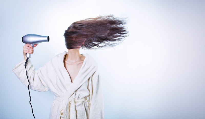 woman blow drying hair_New_Love_Times