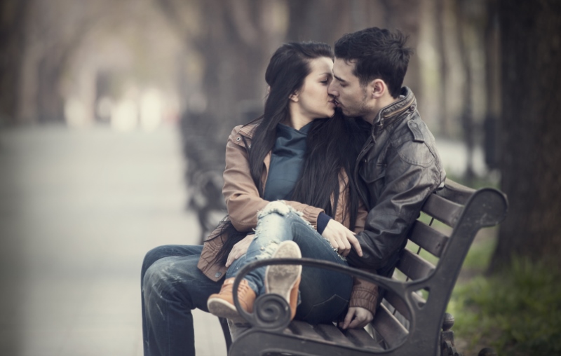 couple cuddling on a bench_New_Love_Times