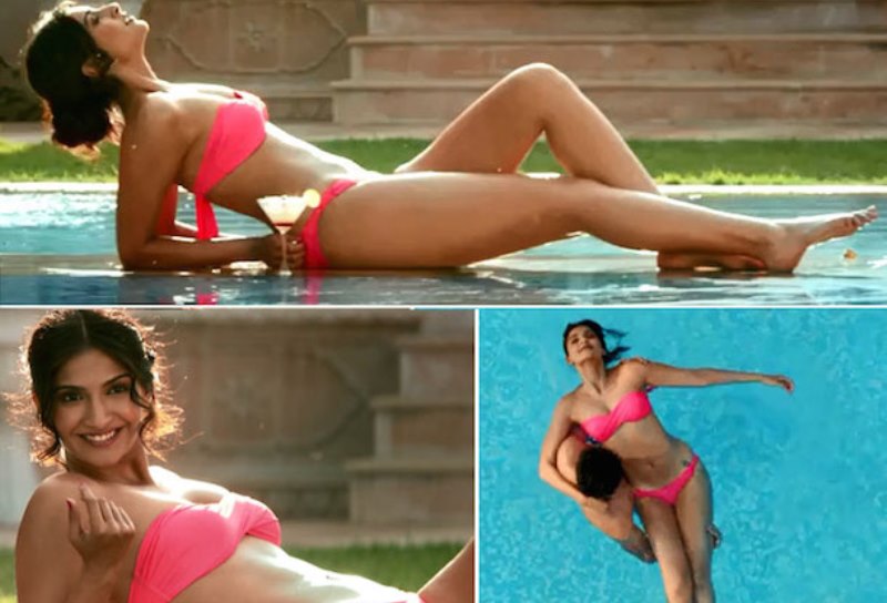 sonam kapoor showing off her flat tummy in a neon pink bikini