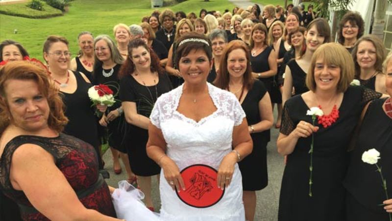 The bride with her long train of bridesmaids!