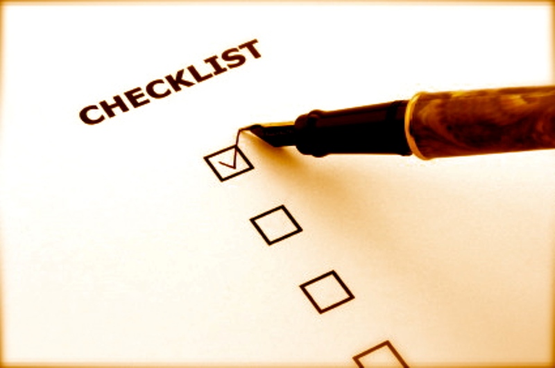 checklist with a ticked box and a pen
