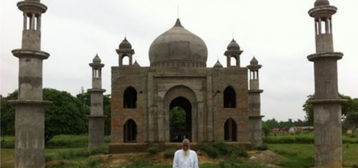 faizul hasan qadri standing in front of the replica of taj mahal that he's building for his late wife