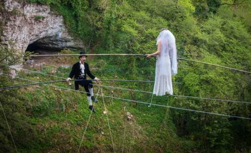 phoebe baker making her way towards her groom chris bull, on a high wire
