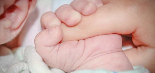 baby holding a finger