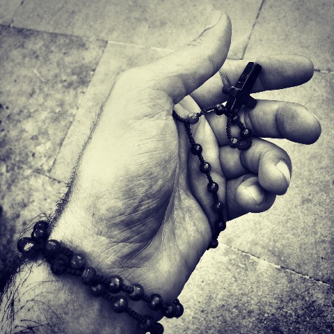man holding rosary
