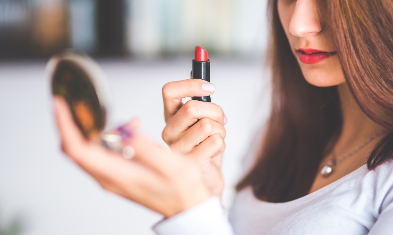 woman applying lipstick_New_Love_Times
