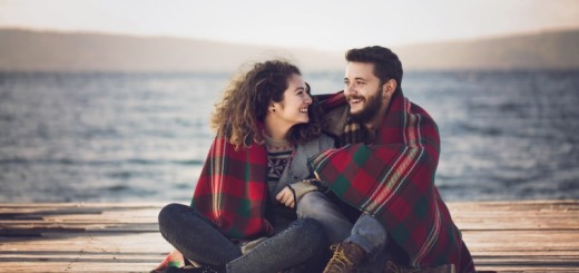 couple huddled under a blanket together