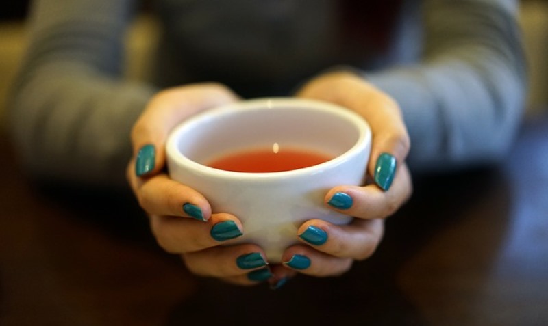 woman holding a teacup