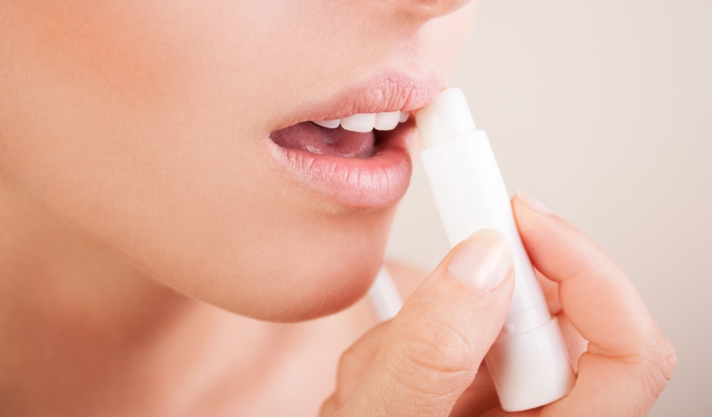 woman applying lip balm_New_Love_Times