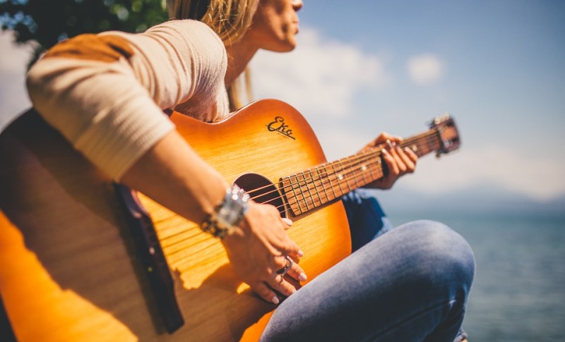 woman playing a guitar_New_Love_Times