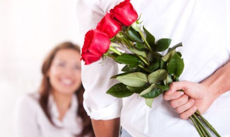 man giving flowers to a woman_New_Love_Times