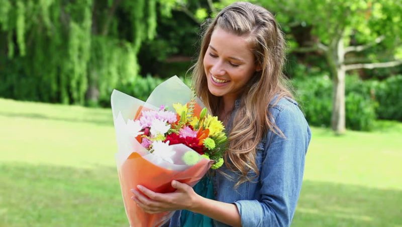 woman holding flowers_New_Love_Times